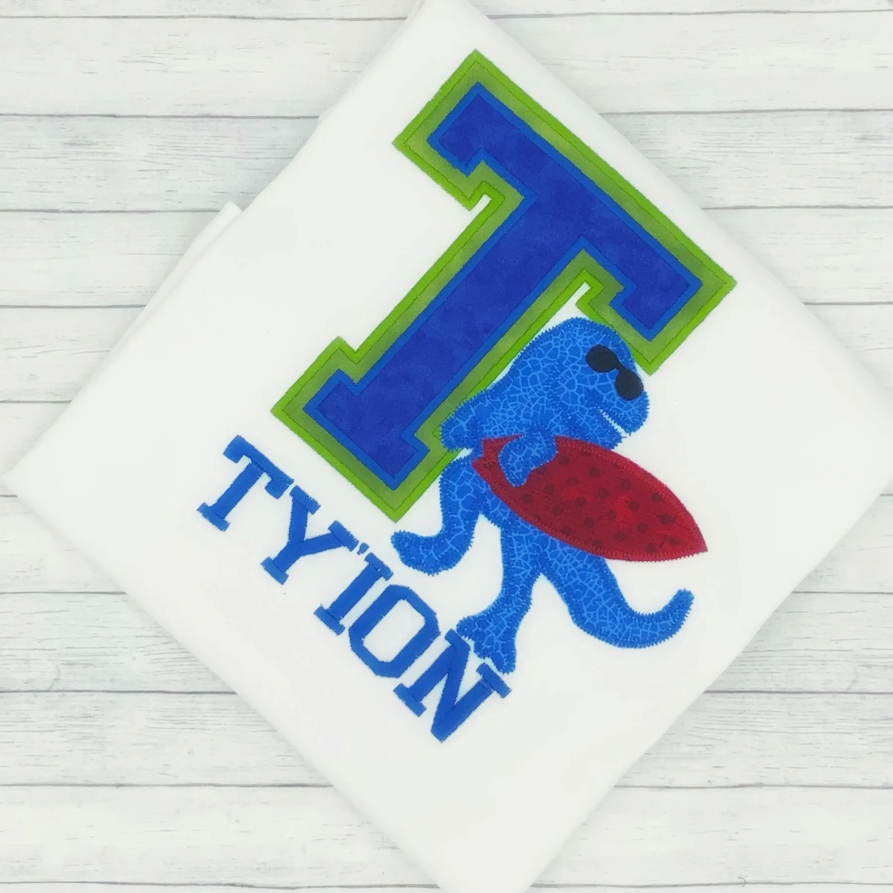 Dinosaur w/ Surf board - Varsity Name Shirt